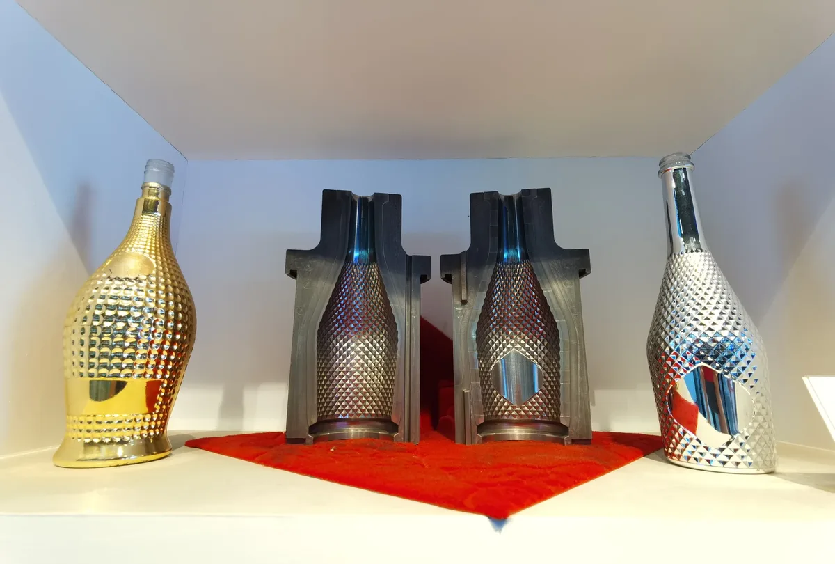 Carbon graphite glass moulds with finished bottles — precision mould to product
